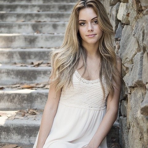 Photo of a woman stood at the bottom of a stone staircase